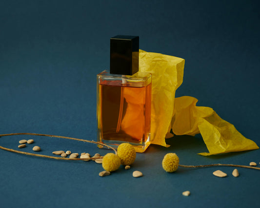 Close up of the Velora Prima bottle with warm yellow fabric