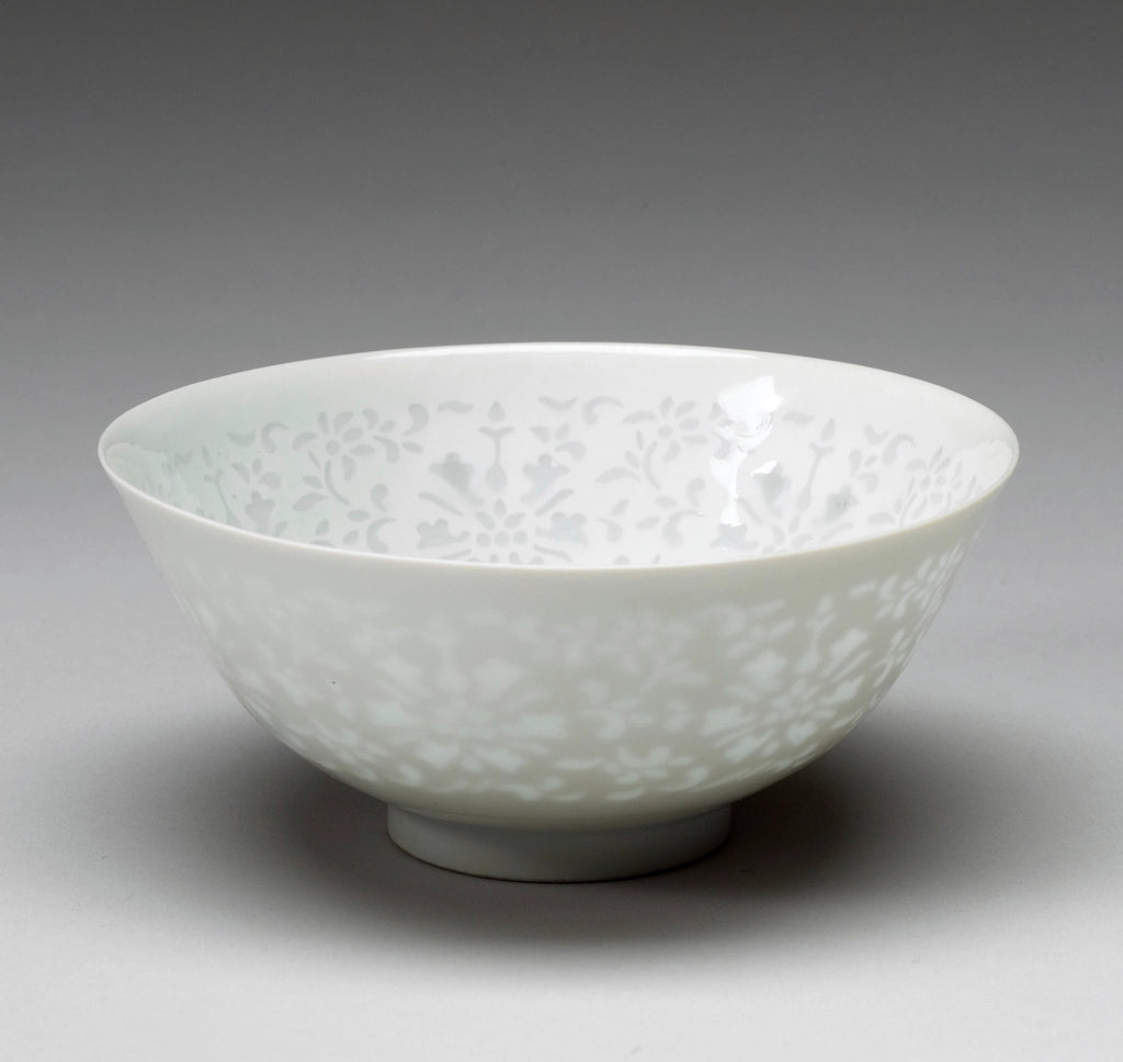 White porcelain rice bowl with a delicate floral pattern